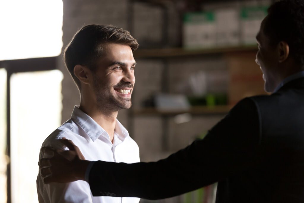 Happy employee talking to boss